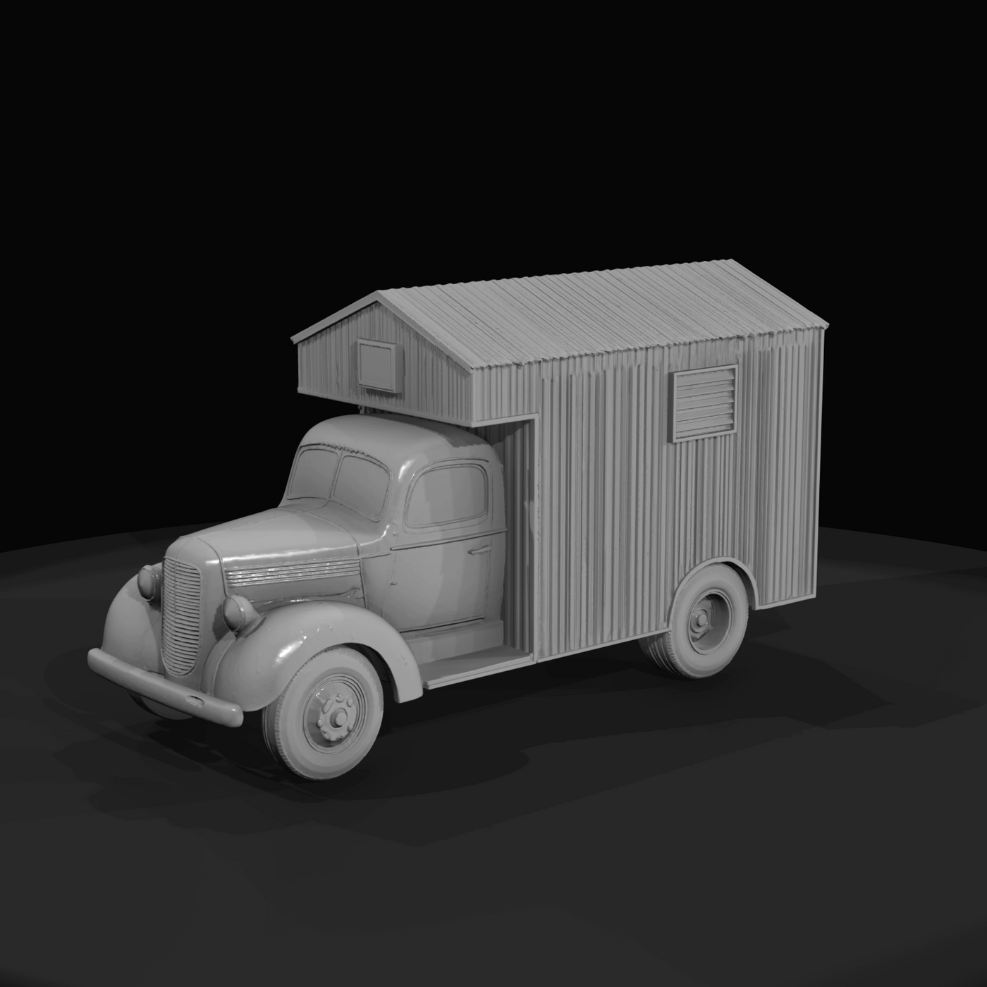 Period light-duty truck chassis with a corrugated metal or wooden mobile-cabin body mounted on the bed