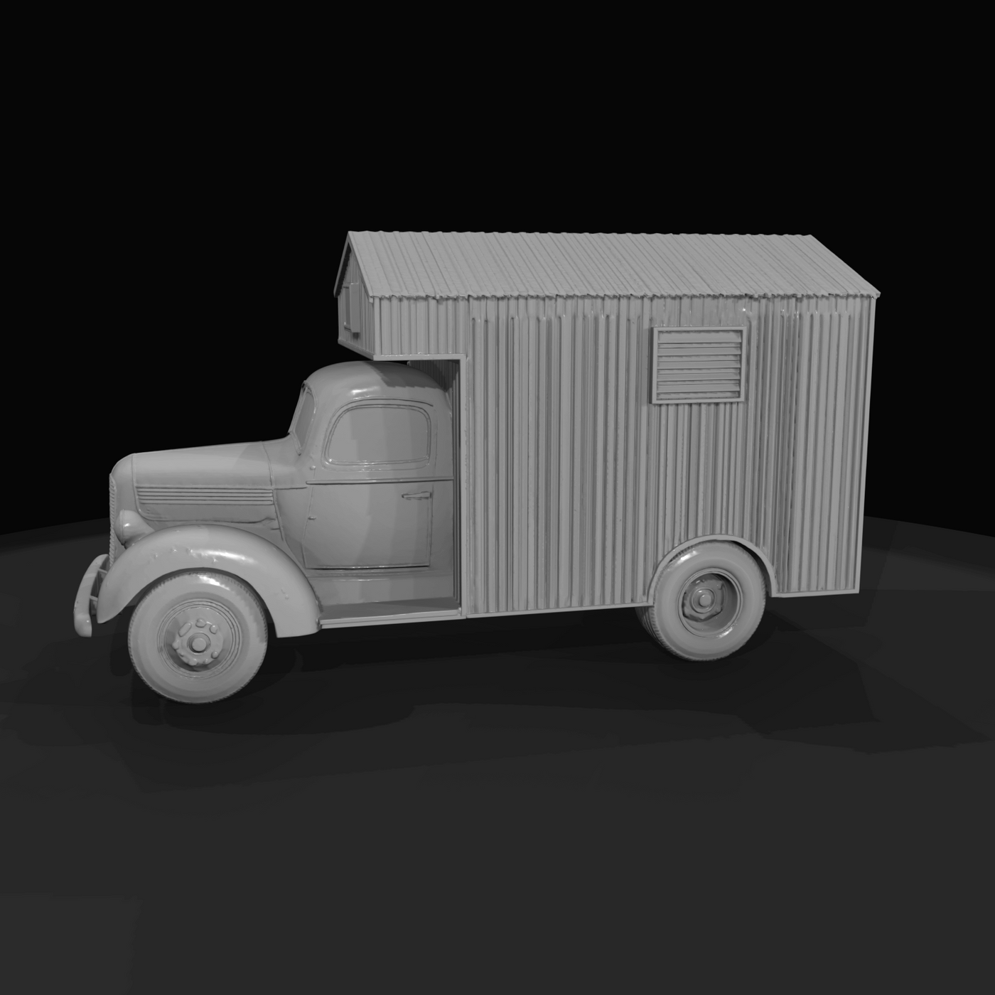 Period light-duty truck chassis with a corrugated metal or wooden mobile-cabin body mounted on the bed